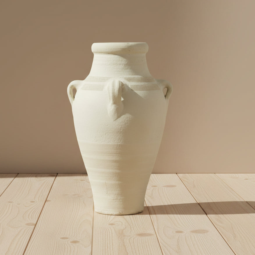 Terracotta vase with four handles on a wooden floor