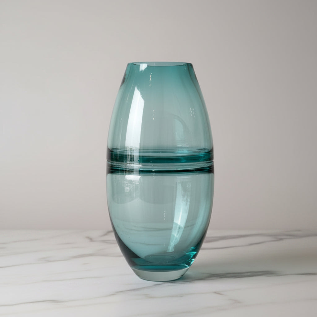 Turquoise glass vase on a light gray background