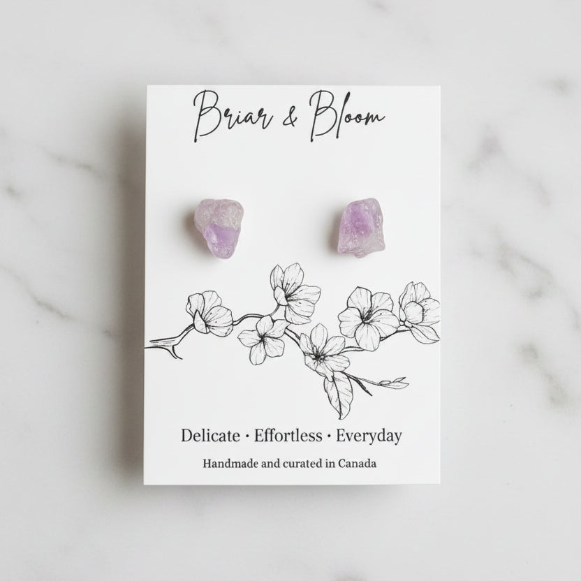 A pair of small Amethyst stud earrings.