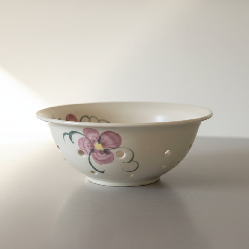 Decorative colander with floral painted accents