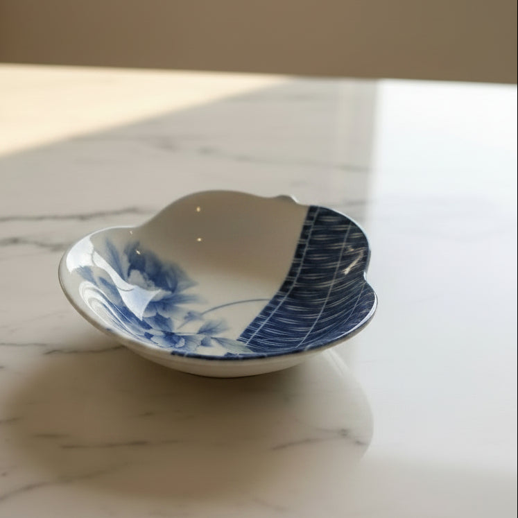 A pear-shaped decorative bowl with a blue and white floral design.