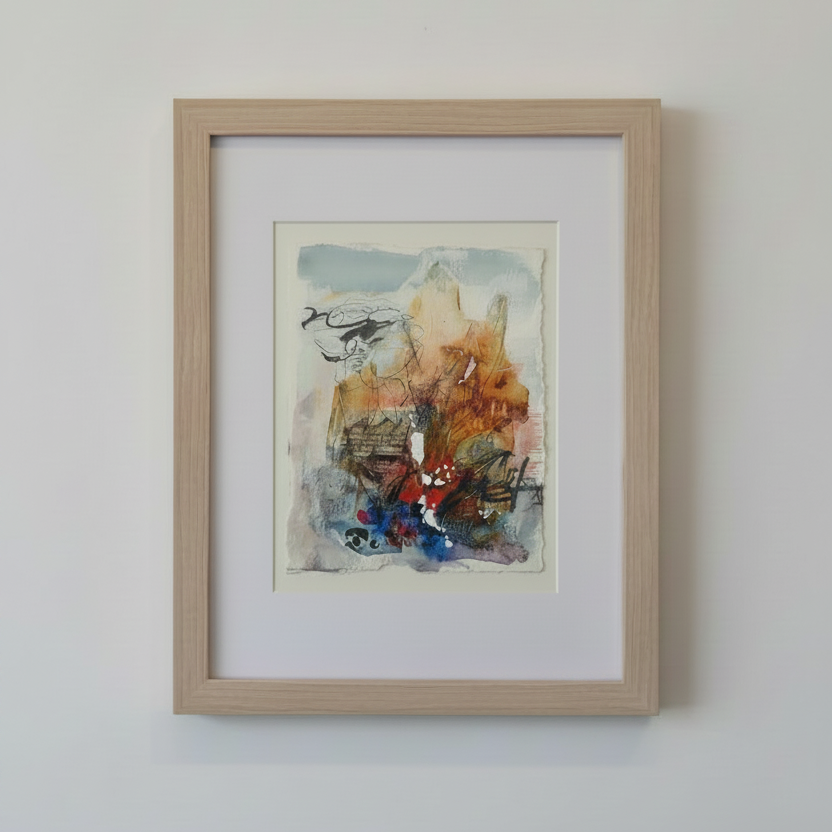 A framed abstract painting with earthy tones of brown, orange, blue, and red, presented in a light natural wood frame.
