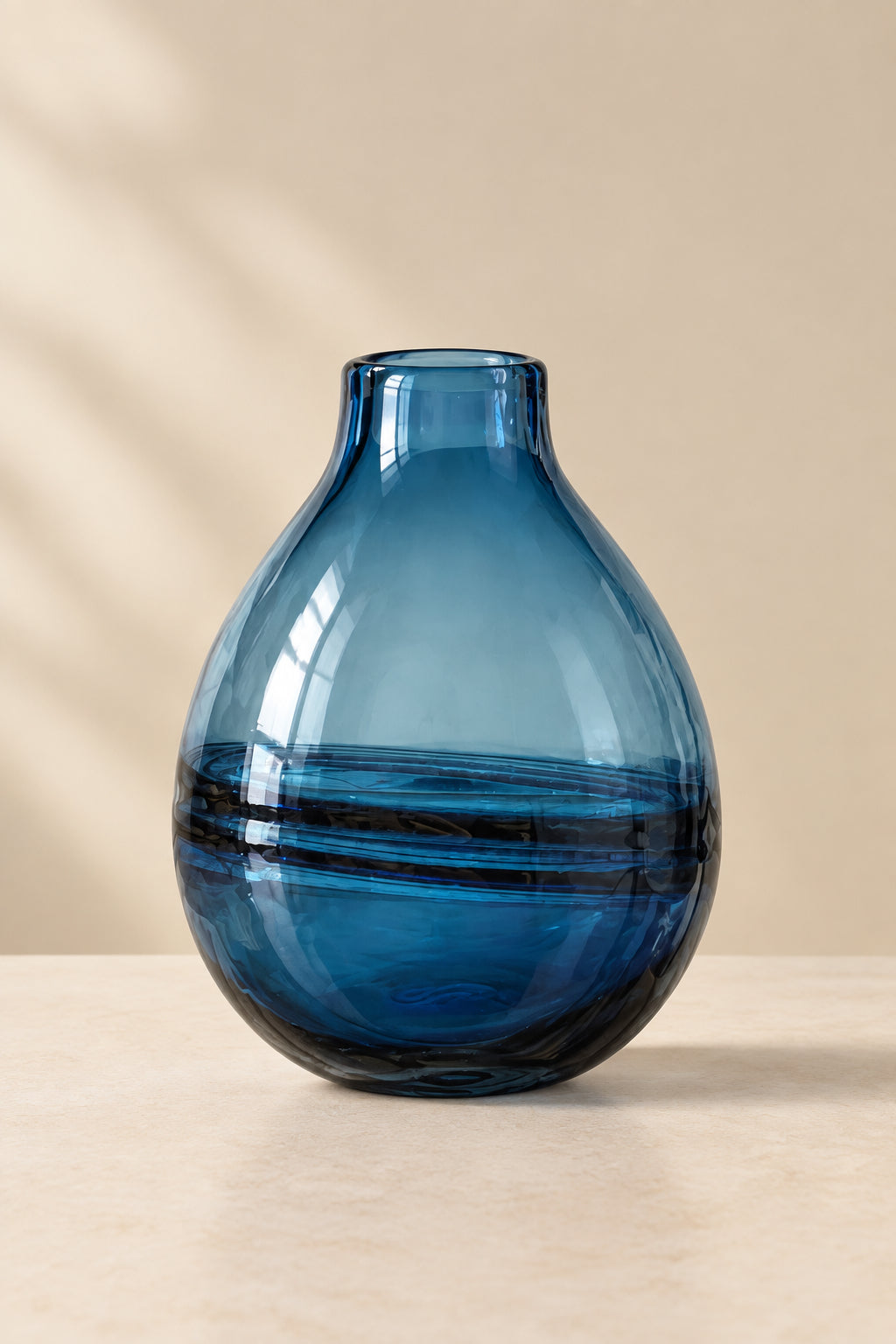 A translucent blue glass vase with a rounded teardrop shape.