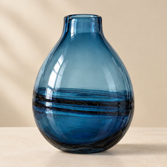 A translucent blue glass vase with a rounded teardrop shape.