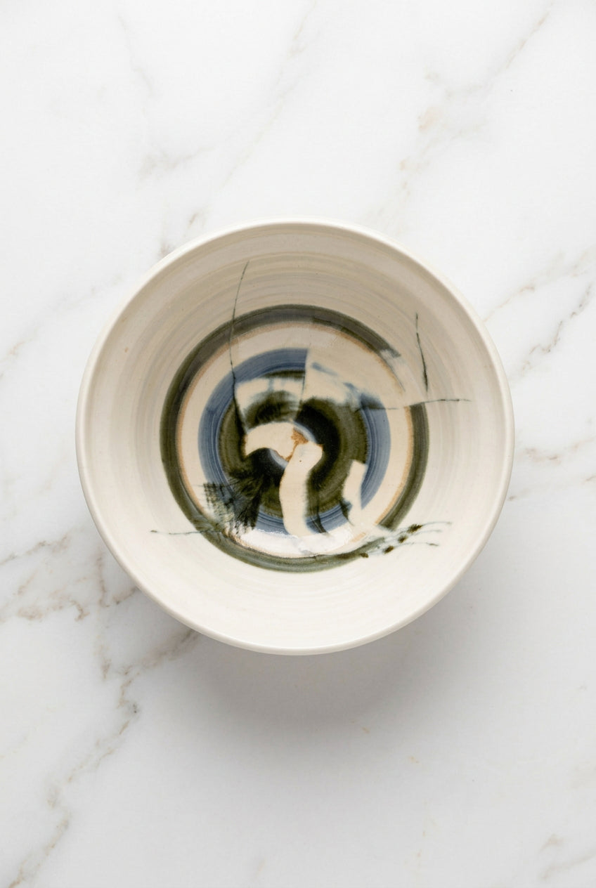 A green and blue abstract ceramic bowl.