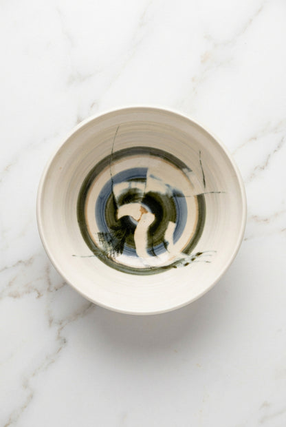 A green and blue abstract ceramic bowl.