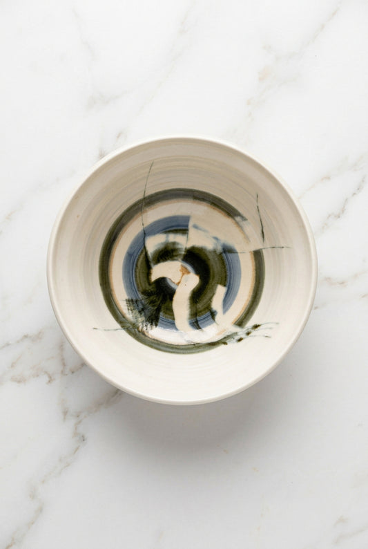 A green and blue abstract ceramic bowl.