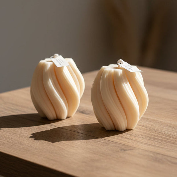 Swirl shapped candles on a wood counter