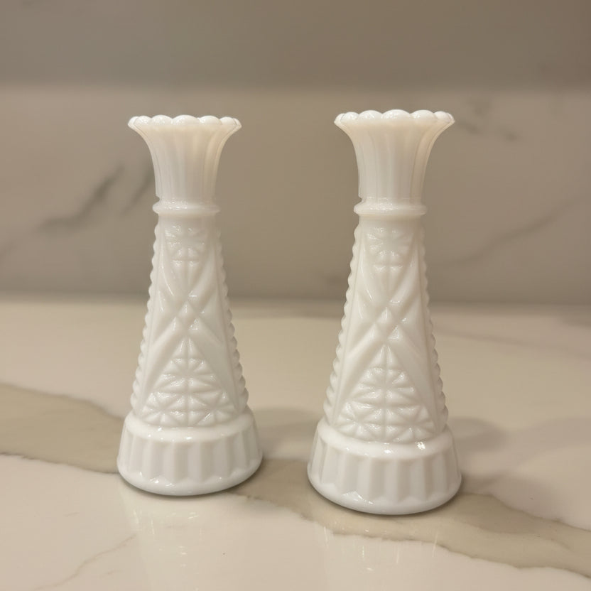 Two milk glass bud vases with textured geometric patterns.