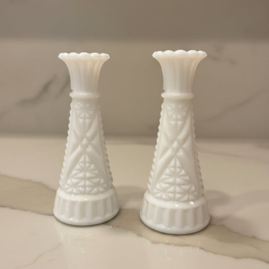 Two milk glass bud vases with textured geometric patterns.