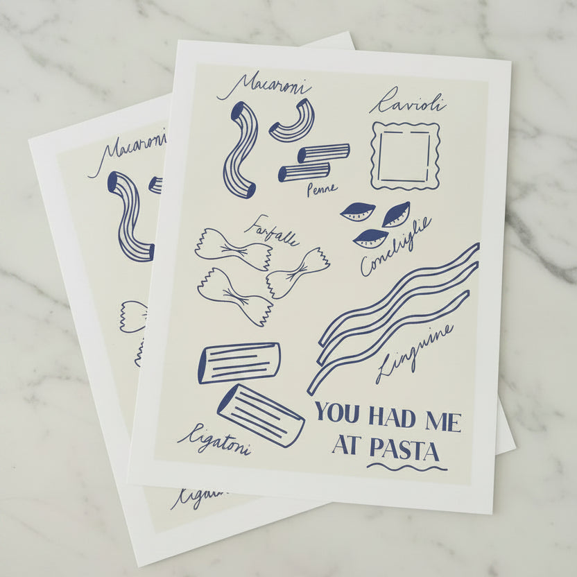 A stack of pasta-themed art prints featuring blue line drawings of various pasta shapes and handwritten labels, with the phrase 'YOU HAD ME AT PASTA' 