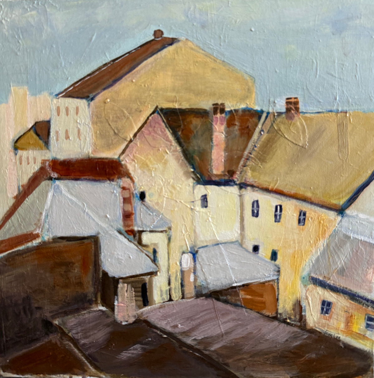 An impressionistic painting of a European-style village scene with cream, ochre, and brown buildings under a pale blue sky, rendered with thick textured brushstrokes.